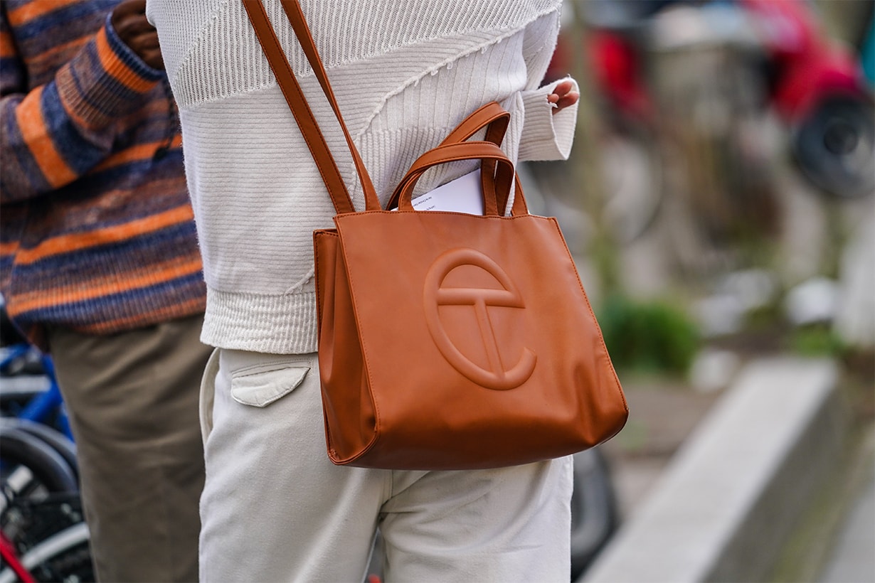 A guest wears a white knit sweater, white pants, a crossbody tan-color bag, outside Wooyoungmi, during Paris Fashion Week - Menswear F/W Fall/Winter 2020-2021 on January 18, 2020 in Paris, France.