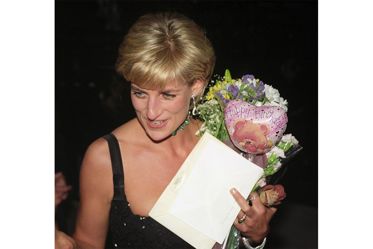 Diana, Princess of Wales, leaves the Tate Gallery's Centenary Gala Dinner carrying birthday gifts she received from friends for her 36th birthday. 