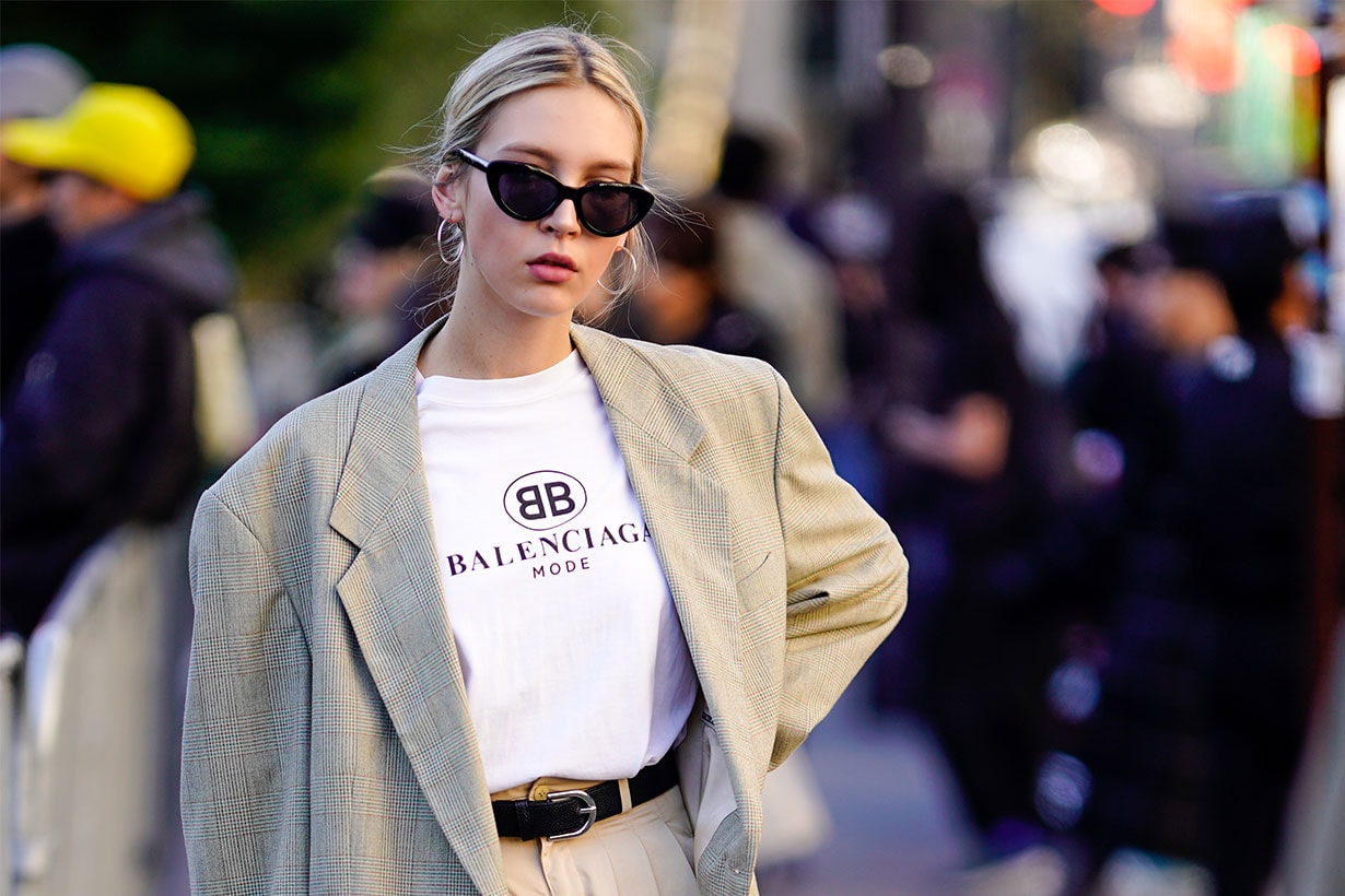 A guest wears an oversized blazer jacket, a wite Balenciaga t-shirt, a belt, beige pants, outside Chloe, during Paris Fashion Week Womenswear Spring/Summer 2019, on September 27, 2018 in Paris, France.
