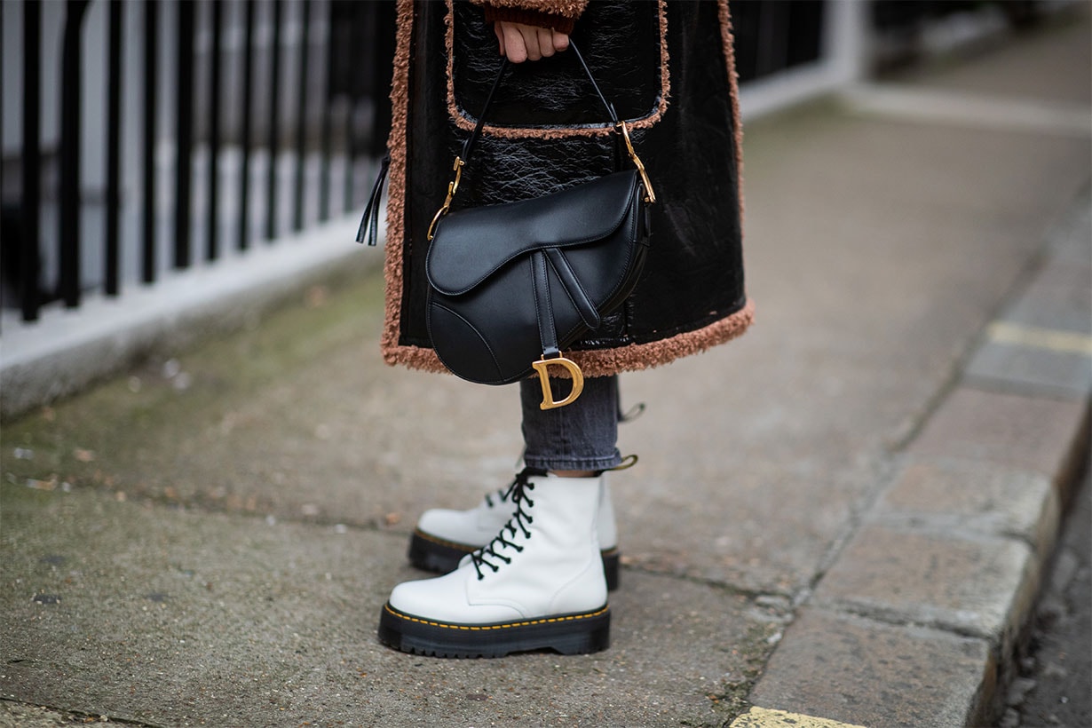 Sonia Lyson is seen wearing white Dr Martens boots, Levis jeans, black Dior saddle bag during London Fashion Week February 2019 on February 18, 2019 in London, England.