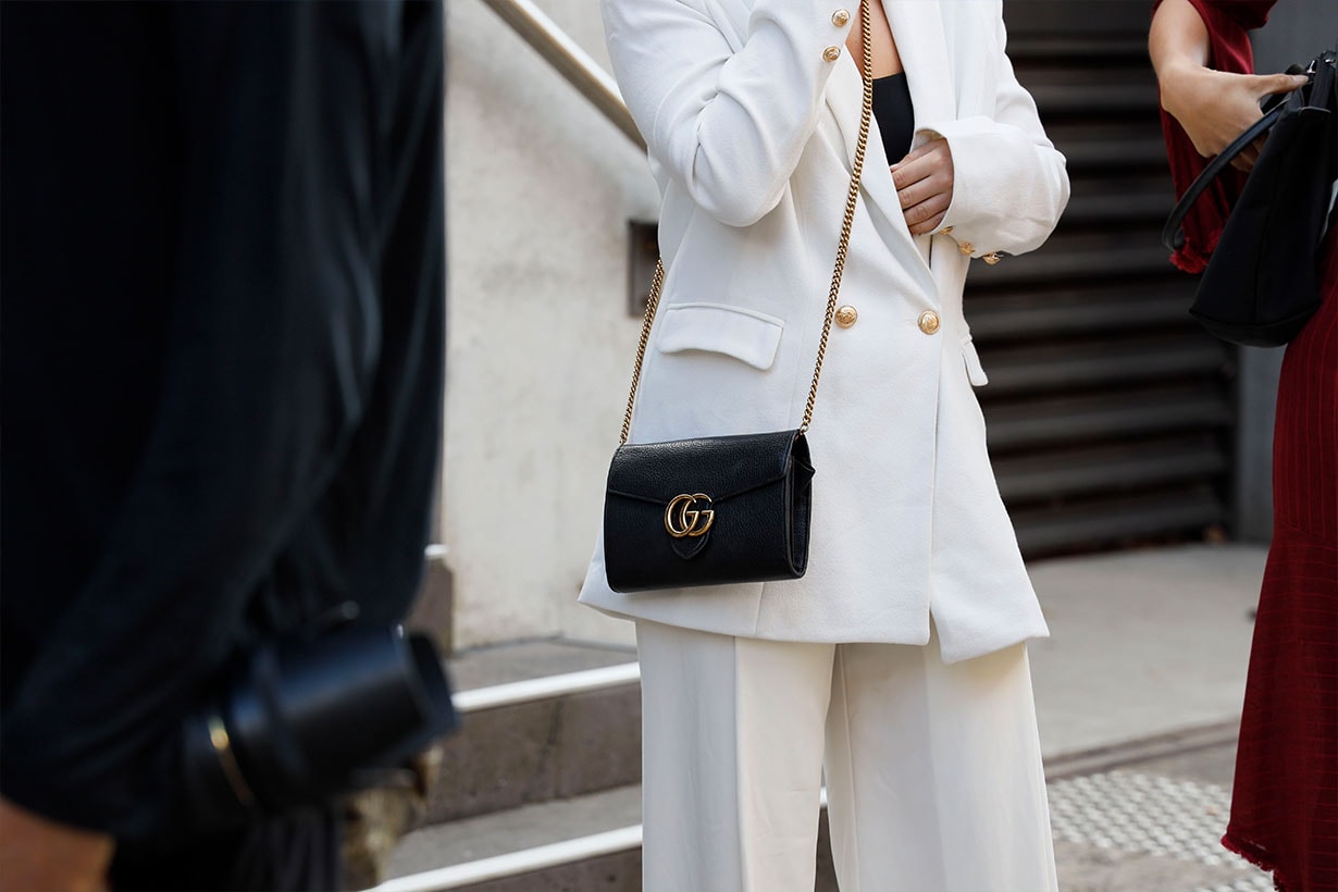 A guest wearing white suit and Gucci bag at Mercedes-Benz Fashion Week Resort 20 Collections on May 15, 2019 in Sydney, Australia.