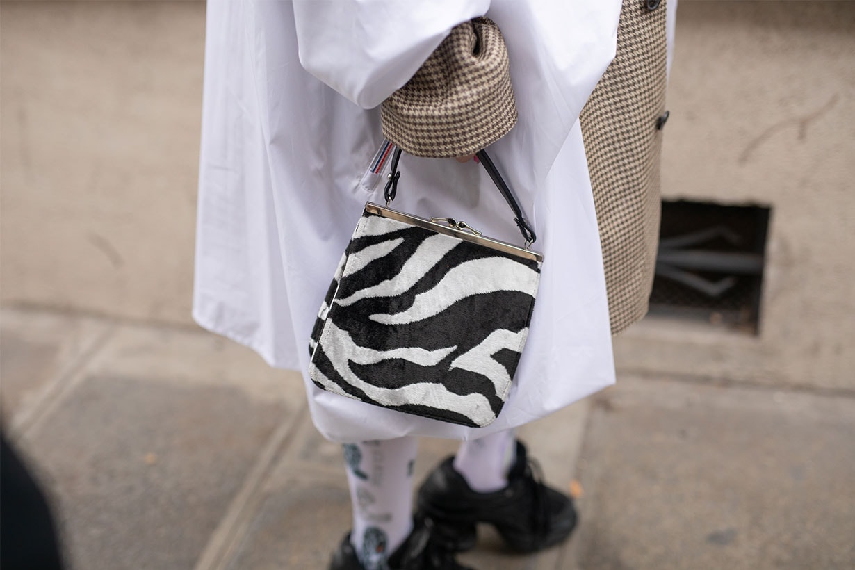 A guest is seen on the street attending Y/PROJECT during Paris Fashion Week AW19 wearing zebra print bag on February 28, 2019 in Paris, France.