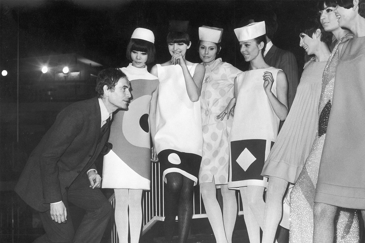 Pierre CARDIN showing his models how to curtsey. These models, wearing clothing created by P. CARDIN, will be curtseying in front of Princess Margaret who has been invited to the spring showing of Pierre CARDIN'S collection at the Commonwealth Institute in Kensington district, London.