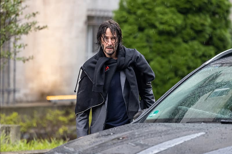 Keanu Reeves sports wet hair exiting hotel Berlin John Wick 4