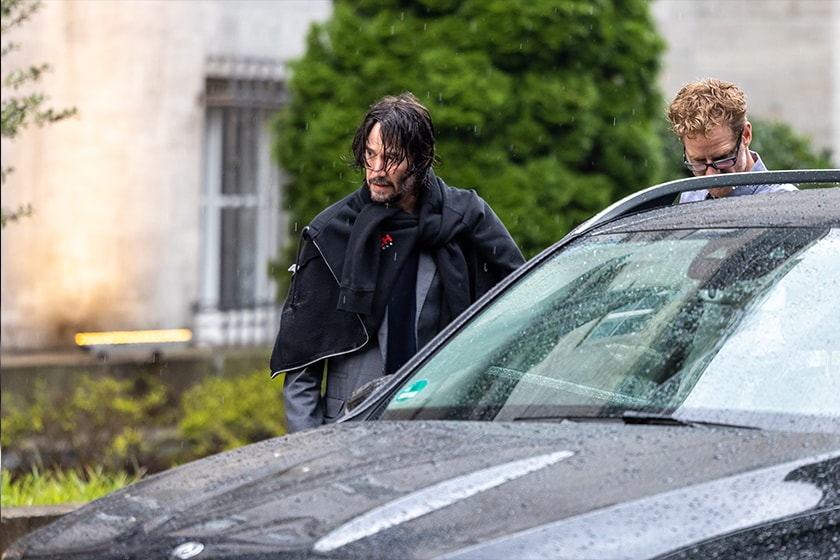 Keanu Reeves sports wet hair exiting hotel Berlin John Wick 4