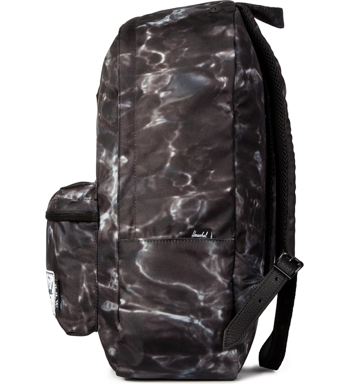 Raised by Wolves x Herschel Supply Co. Water Camo Woodlands Backpack  Placeholder Image