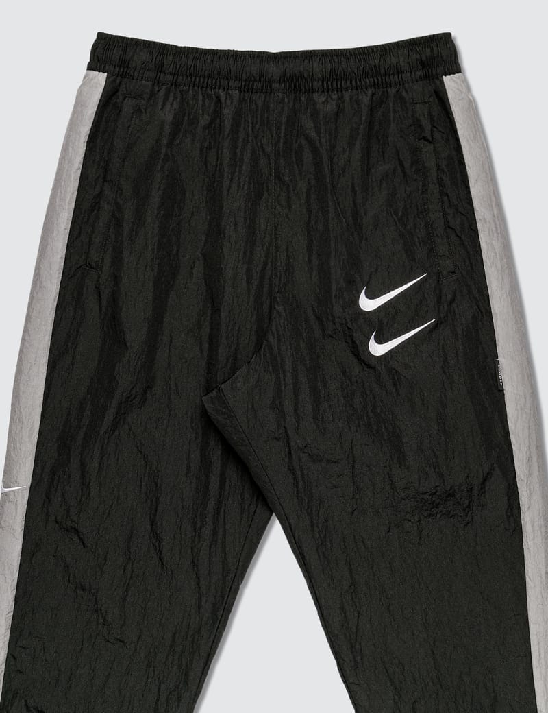 nike swoosh woven trousers