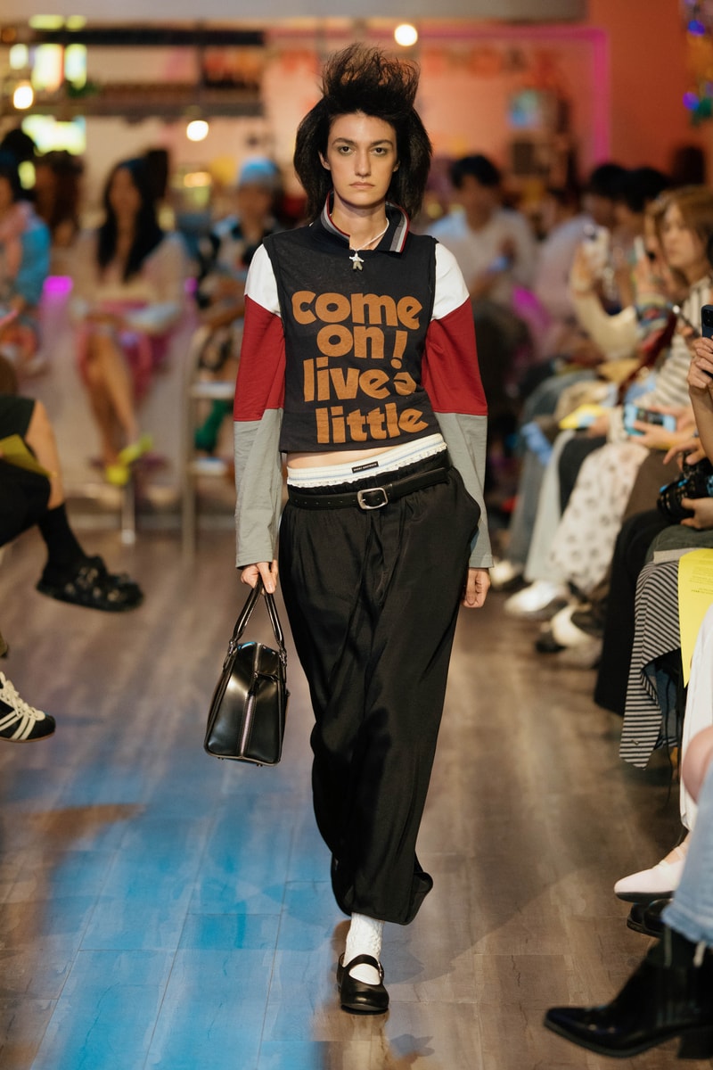 2026 runway look featuring a prominent slogan shirt