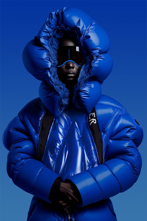 Model wearing a sculptural cobalt-blue Moncler Genius puffer jacket.