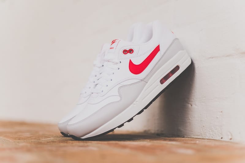 White leather nike on sale with red swoosh