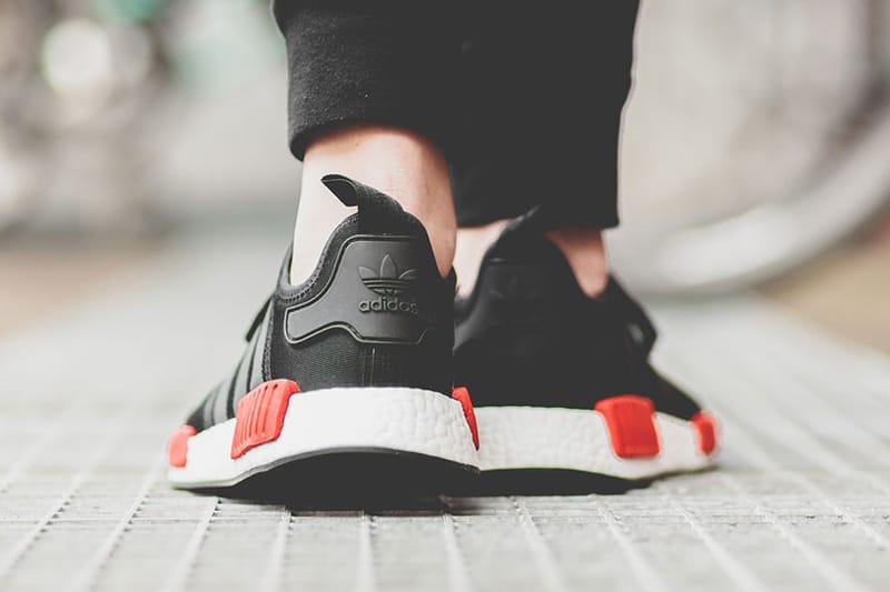 Nmd black clearance red on feet