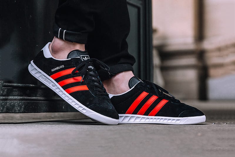 Black adidas with red stripes online