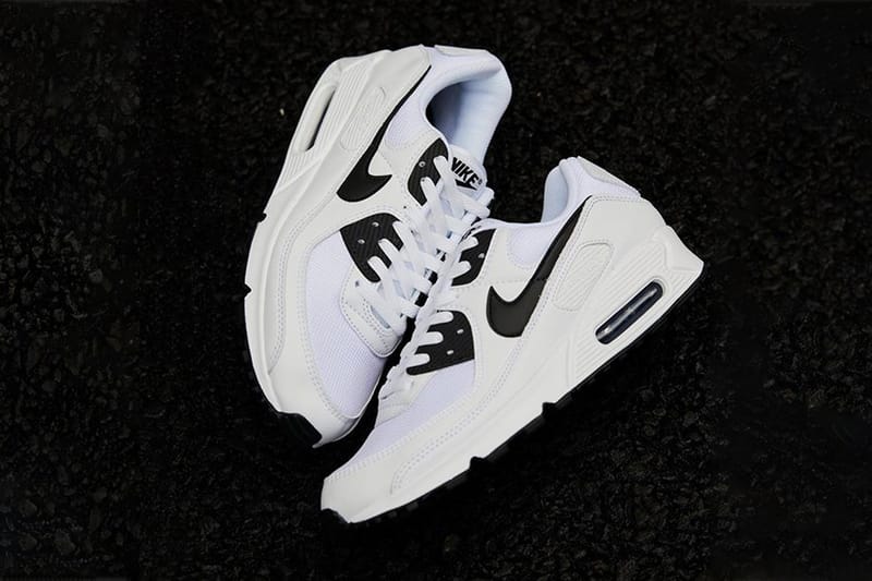 Nike white shoes hot sale with black swoosh