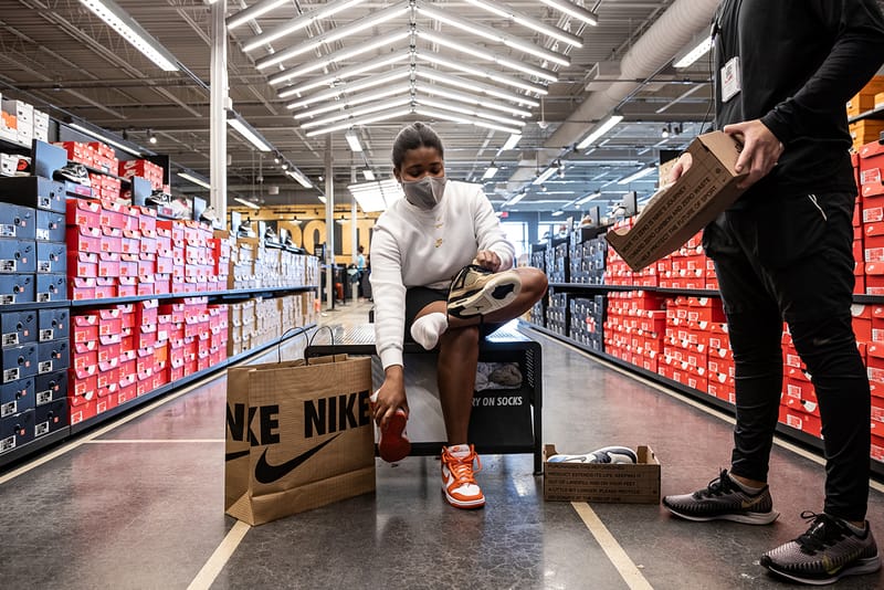 Customers walking out of sale a nike store with shoes