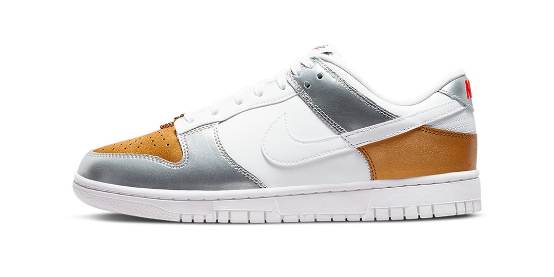 Цветовая гамма Nike Dunk Low сочетает в себе серебряные и золотые акценты