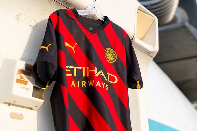 Man city red store and black kit