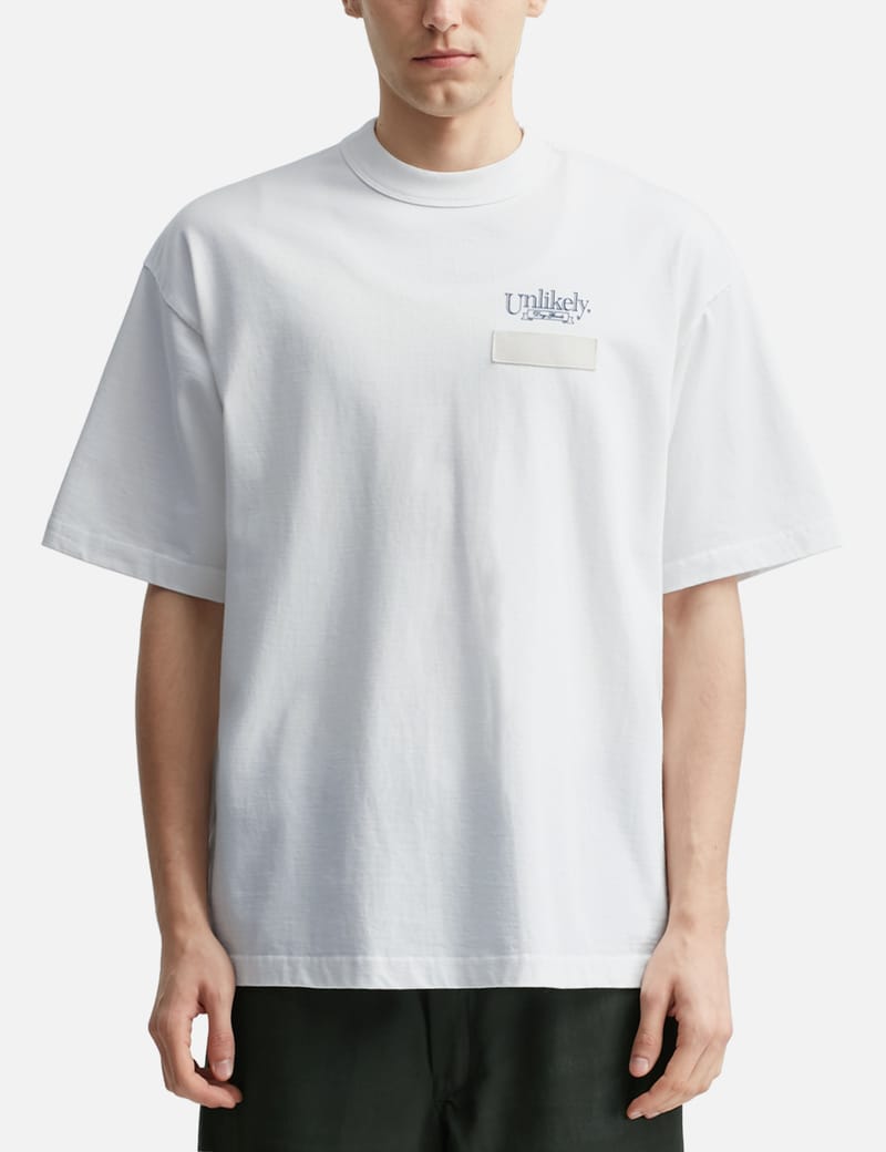 Unlikely Unlikely Team Tee - 日本製のルーズフィット半袖T。胸ロゴ
