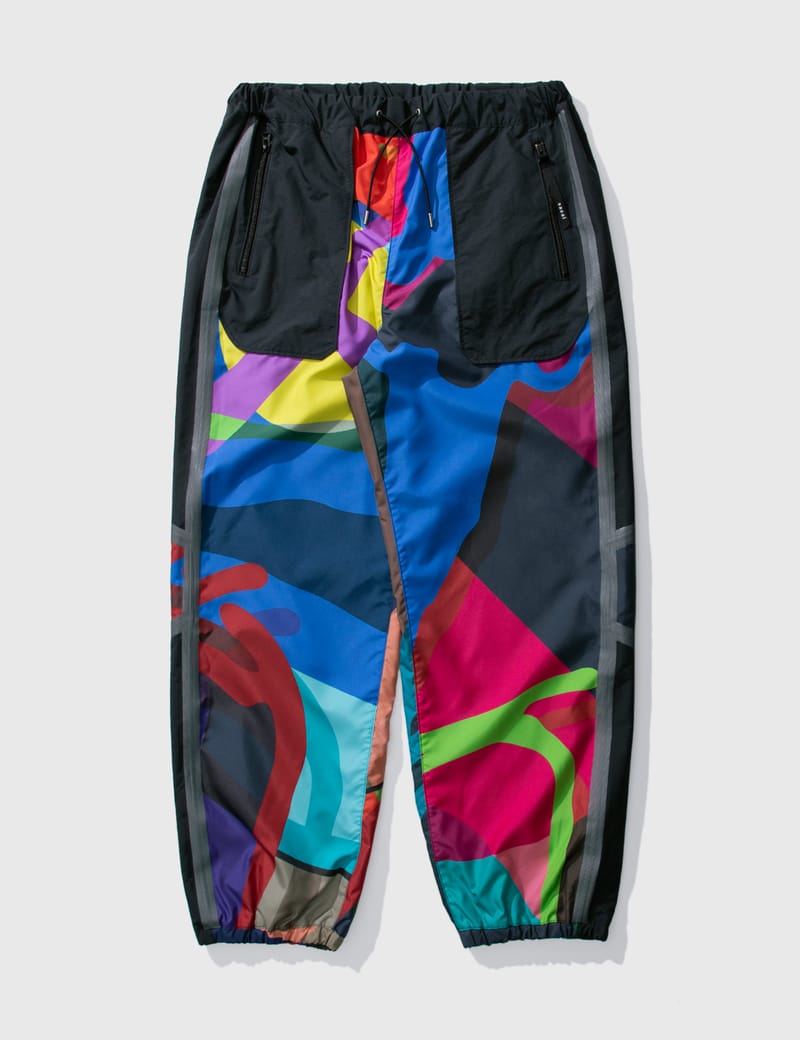 Sacai - KAWS Print Pants | HBX - Globally Curated Fashion and