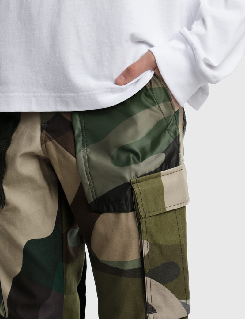 Sacai - KAWS Print Pants | HBX - Globally Curated Fashion and